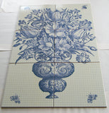 An antique vase with flowers.  Bathroom tile mosaic/Kitchen backsplash.