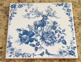Vintage-style kitchen trivet on ceramic tile. Ceramic tile art with deer and flowers in blue and brown colors. Retro-style tile trivet.