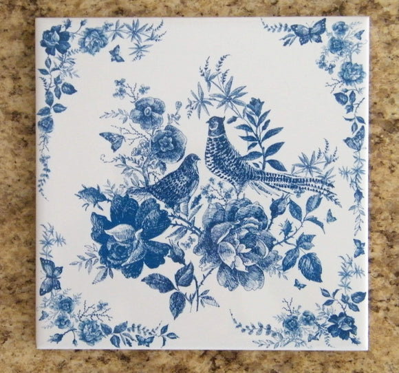 Painting with 2 birds and flowers in blue colors. Ceramic trivet