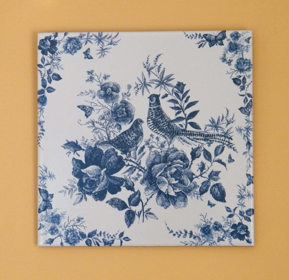 Painting with 2 birds and flowers in blue colors. Ceramic tile